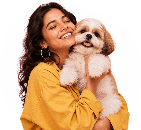 A woman hugging her shih tzu